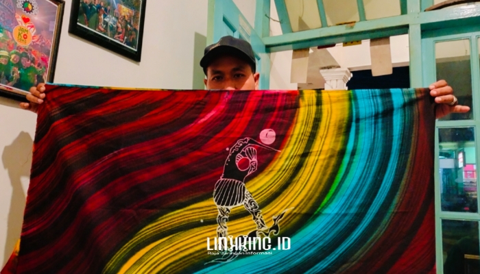 KARYA. Potret Owner Dermaga Batik, Moh. Erfan, saat menunjukkan karya batik kontemporernya dengan tema Ojhung. (Dok. Redaksi Linkking.id)